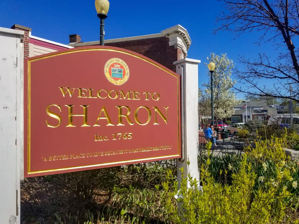 A red sign that reads "Welcome to Sharon" is a landmark in Sharon, MA, a service area of Sinclaire Home Services.